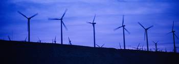 Wind turbines in a row at dusk