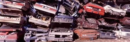 Pile of demolished cars at a junkyard