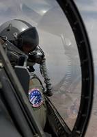 An F-16 pilot checks the position of his wingman d