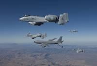Four A-10C Thunderbolts prepare to refuel from a K
