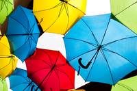 Many colorful umbrellas against the sky